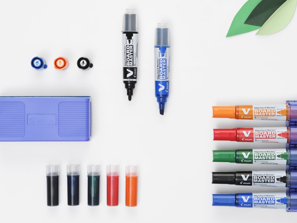 V Board Master Whiteboard Markers on a whiteboard, 5 closed markers, 2 without caps.
